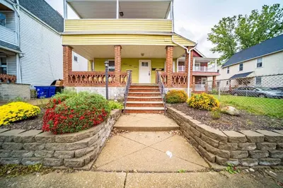 a home with a stone stairway leading to the front door at Little Italy Gem Close to CWRU, Cleveland Clinic & Top Restaurants w King Bed in Cleveland