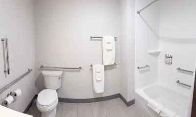 a bathroom with a toilet and a tub and a sink at Holiday Inn Express & Suites Mansfield - Ontario by IHG in Mansfield