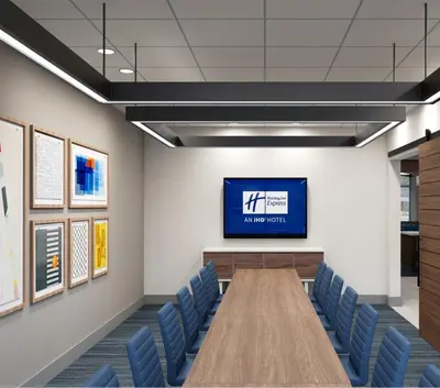 a conference room with a tv and blue chairs at Holiday Inn Express & Suites Mansfield - Ontario by IHG in Mansfield