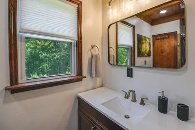 a bathroom with a sink and a mirror at Creek, Trails and Falls! Rural Red River Gorge Cabin in Campton