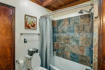 a bathroom with a shower and a toilet at Creek, Trails and Falls! Rural Red River Gorge Cabin in Campton
