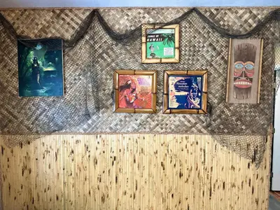 a wall with a bunch of pictures on it at Kikis Tikis! Fun Themed Home in Vermilion