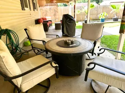 a small table and chairs on a patio at Kikis Tikis! Fun Themed Home in Vermilion