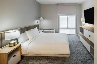 a hotel room with a bed and a television at TownePlace Suites by Marriott Canfield in Canfield