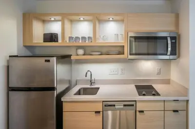 a kitchen with a stainless steel refrigerator and microwave at TownePlace Suites by Marriott Canfield in Canfield