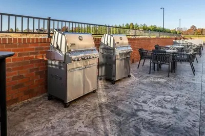 two stoves sitting on a patio next to a table at TownePlace Suites by Marriott Canfield in Canfield