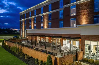 an exterior view of a building with tables and chairs at TownePlace Suites by Marriott Canfield in Canfield