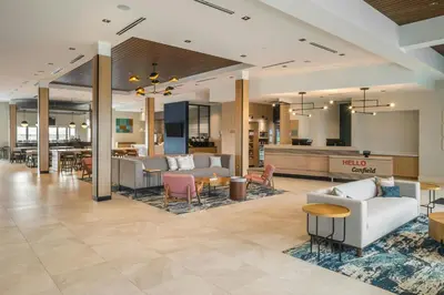 a lobby of a hotel with couches and tables at SpringHill Suites by Marriott Canfield in Canfield