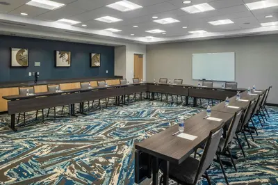 a large room with tables and chairs and a whiteboard at SpringHill Suites by Marriott Canfield in Canfield