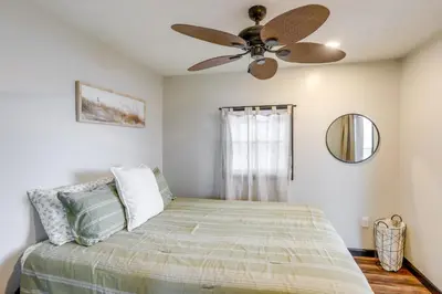 a bedroom with a bed with a ceiling fan at Vickery Cottage on Sandusky Bay with Fire Pit! in Port Clinton