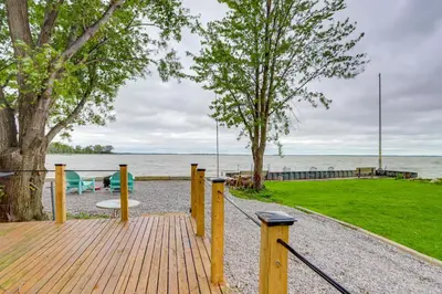 a wooden boardwalk leading to the water with a playground at Vickery Cottage on Sandusky Bay with Fire Pit! in Port Clinton