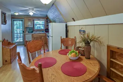 a kitchen with a wooden table with a bowl of fruit on it at Dog-Friendly Home Rental about 5 Mi to Cave Run Lake! in Wellington