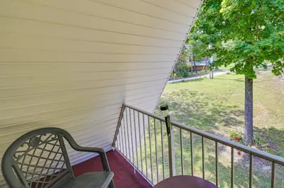 a bench on a porch with a view of a park at Dog-Friendly Home Rental about 5 Mi to Cave Run Lake! in Wellington