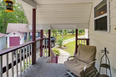 a chair sitting on the porch of a house at Dog-Friendly Home Rental about 5 Mi to Cave Run Lake! in Wellington