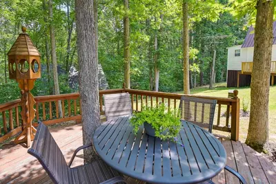a blue table and chairs on a deck with a tree at Dog-Friendly Home Rental about 5 Mi to Cave Run Lake! in Wellington