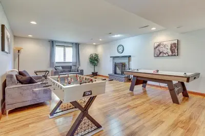 a living room with a ping pong table and a couch at Bolivar Getaway Near Pro Football Hall of Fame! in Bolivar