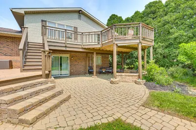 a house with a deck and a patio at Bolivar Getaway Near Pro Football Hall of Fame! in Bolivar