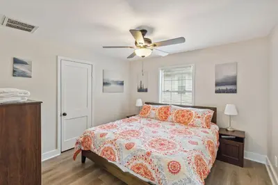 a bedroom with a bed and a ceiling fan at Elm Two Bedroom House in Historic Loveland in Loveland