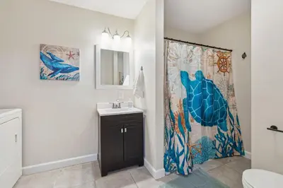 a bathroom with a shower curtain and a sink at Elm Two Bedroom House in Historic Loveland in Loveland