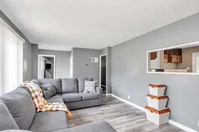 a living room with a couch and a table at Cozy Retreat in Cincinnati home in Cincinnati
