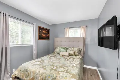 a bedroom with a bed and a flat screen tv at Cozy Retreat in Cincinnati home in Cincinnati