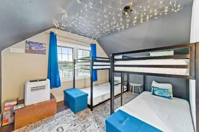 a bedroom with two bunk beds and a ceiling with lights at Cottage for 12, Close to Ark, Private Parking, 4BR in Williamstown