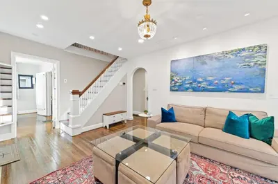 a living room with a couch and a table at Cottage for 12, Close to Ark, Private Parking, 4BR in Williamstown