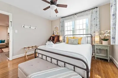 a bedroom with a bed and a ceiling fan at Cottage for 12, Close to Ark, Private Parking, 4BR in Williamstown