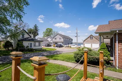 a house with a rope fence in a neighborhood at Buckeye Lake Cottage