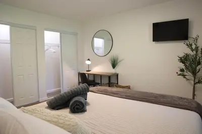 a bedroom with a bed and a mirror and a desk at 5-BR Serene Retreat Near CLE* Dogs welcome! in Berea