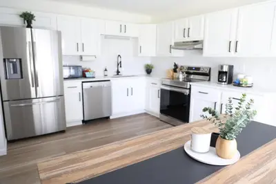 a kitchen with white cabinets and stainless steel appliances at 5-BR Serene Retreat Near CLE* Dogs welcome! in Berea