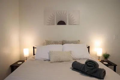 a bedroom with a bed with two lamps on it at 5-BR Serene Retreat Near CLE* Dogs welcome! in Berea
