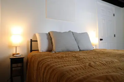 a bedroom with a large bed with two lamps on tables at 5-BR Serene Retreat Near CLE* Dogs welcome! in Berea
