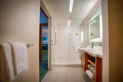 a bathroom with a sink and a shower and a mirror at SpringHill Suites by Marriott Canton in North Canton