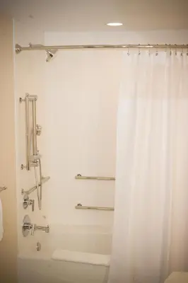 a bathroom with a shower with a white shower curtain at SpringHill Suites by Marriott Canton in North Canton