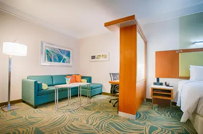a hotel room with a couch and a bed at SpringHill Suites by Marriott Canton in North Canton