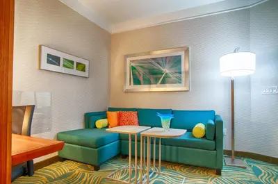 a living room with a blue couch and a table at SpringHill Suites by Marriott Canton in North Canton