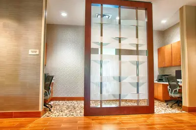an office lobby with a glass door and a desk at SpringHill Suites by Marriott Canton in North Canton