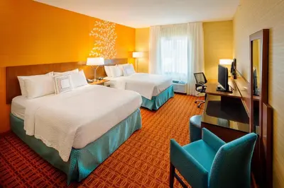 a hotel room with two beds and a television at Fairfield Inn and Suites by Marriott Monaca in Monaca