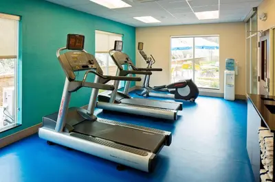 a gym with three tread machines in a room at Fairfield Inn and Suites by Marriott Monaca in Monaca