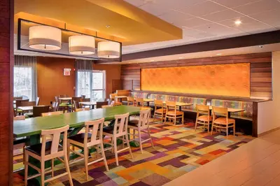 a dining room with a large table and chairs at Fairfield Inn and Suites by Marriott Monaca in Monaca