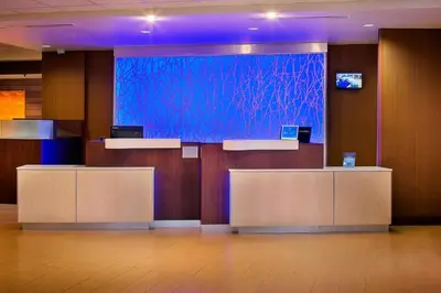 a lobby with a large screen in a building at Fairfield Inn and Suites by Marriott Monaca in Monaca