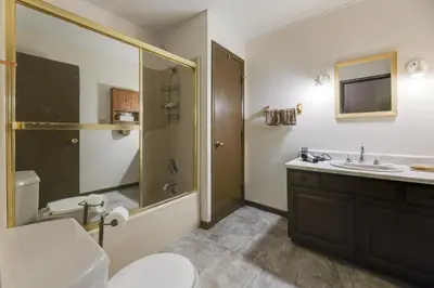 a bathroom with a toilet and a sink and a shower at Riverfront Covington Cabin with Deck and Fire Pit! in Piqua