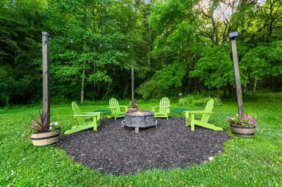 a group of chairs and a fire pit in a yard at Frog Hollow at Hocking Vacations in Logan