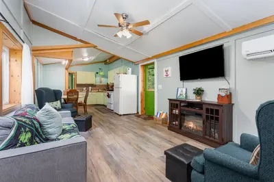 a living room with a couch and a tv and a fireplace at Frog Hollow at Hocking Vacations in Logan