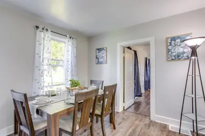 a dining room with a table and chairs at Cozy Greenwich Vacation Rental with Fire Pit in Greenwich