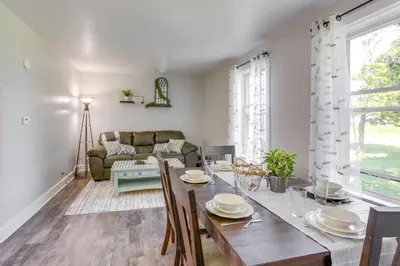 a dining room with a table and a couch at Cozy Greenwich Vacation Rental with Fire Pit in Greenwich