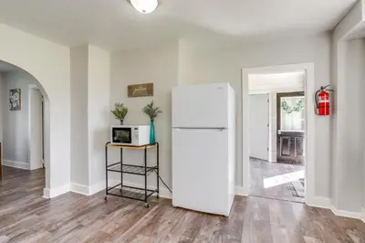 a kitchen with a white refrigerator in a room at Cozy Greenwich Vacation Rental with Fire Pit in Greenwich