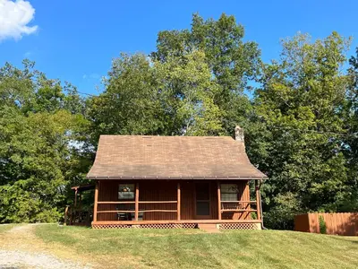 a small cabin on a hill with trees at Athens and Albany's Hillside Haven in Albany