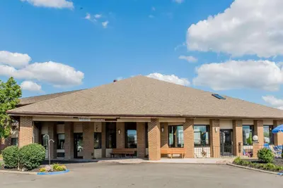 a brick building with a bench in front of it at Baymont by Wyndham Lancaster in Lancaster